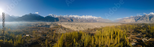 Aerial view of Katpana Desert with snow capped mountains and remote valley, Skardu, Pakistan.