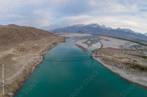 Aerial view of Indus River with snow capped mountains and serene lake, Skardu, Pakistan. photo