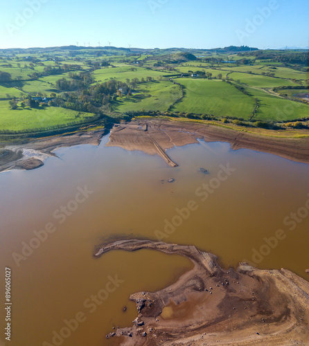 Aerial view of Balgray Reservoir surrounded by fields, hills, and trees, Barrhead, Scotland. photo