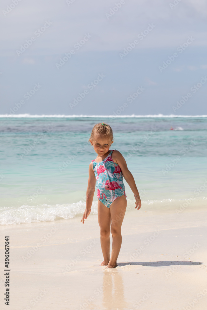 Girl swims in the ocean, summer vacation, vitamin D, vacation with children Girl swims in the ocean, summer vacation, vitamin D, vacation with children