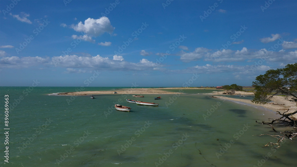 Aerial view of tranquil ocean coast with boats and sand bar, Manaure, Colombia. Aerial view of tranquil ocean coast with boats and sand bar, Manaure, Colombia.