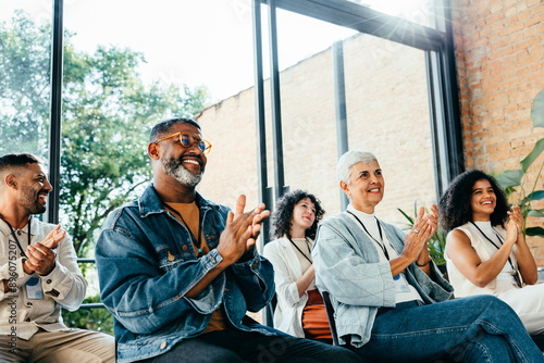 Konstfotografi Diverse group of people attending a business meeting, happily clapping and smili