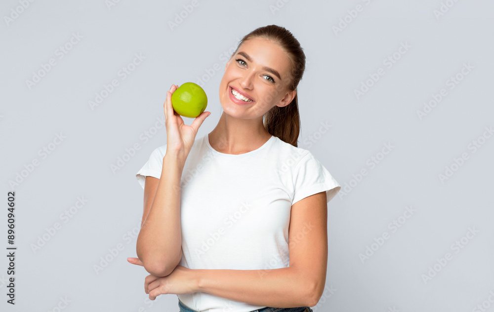 Vegetarianism. Woman Holding Apple Smiling At Camera Posing On White Background In Studio. Isolated Vegetarianism. Woman Holding Apple Smiling At Camera Posing On White Background In Studio. Isolated