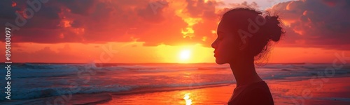 Sunset on a beach with a woman looking out at the ocean, Portrait, Banner © kramynina