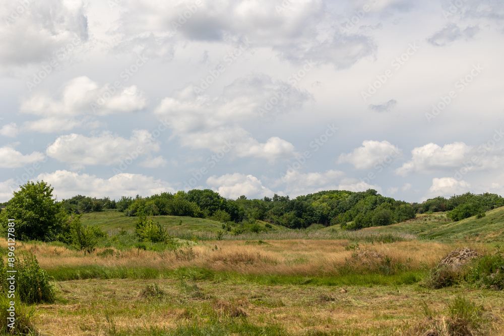 Landscape of a valley with hills and sky in the background Landscape of a valley with hills and sky in the background