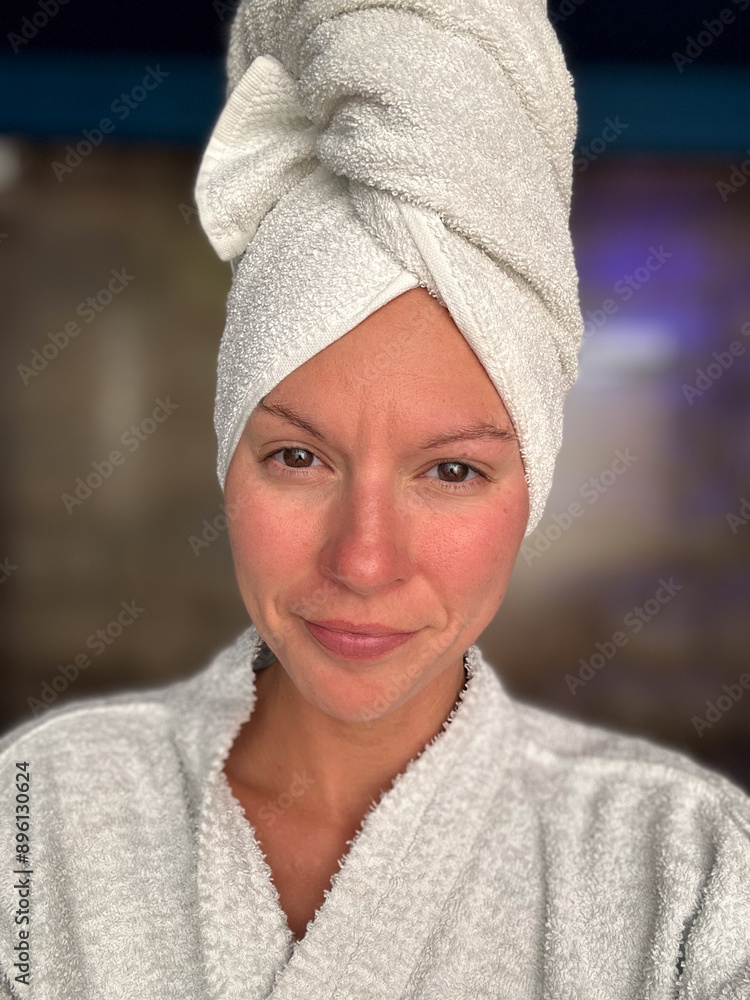 Female with towel wrapped around hair and robe at a spa day. Female with towel wrapped around hair and robe at a spa day.