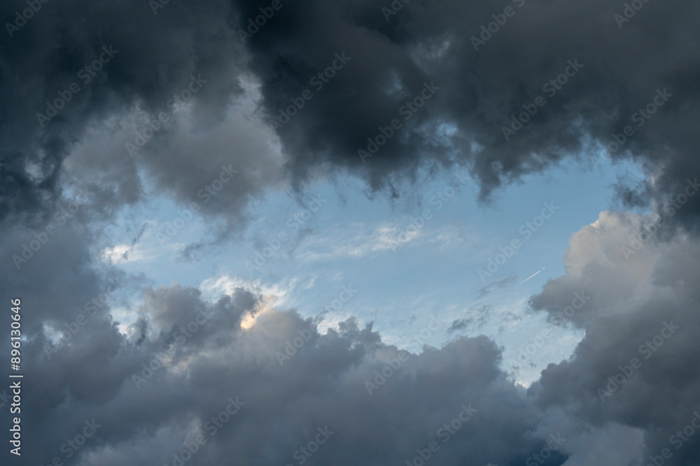 Dramatic sky background with dark rainy clouds at sunset.
Dramatic sky background with dark rainy clouds at sunset.