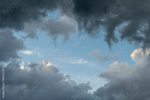 Dramatic sky background with dark rainy clouds at sunset. 