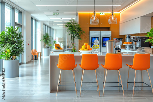 Modern office kitchen offering relaxing break area with orange chairs photo