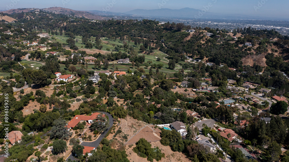 Fototapeta premium Afternoon aerial view of the sprawling neighborhood houses and hills of La Habra Heights, California, USA.
