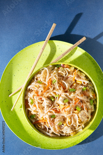 Bright and Sunny Vegetarian Tofu Pad Thai in a lime green bowl and chopsticks photo