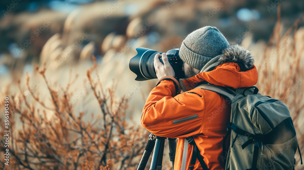 Fototapeta premium An explorer photographs wildlife in a pristine natural habitat.