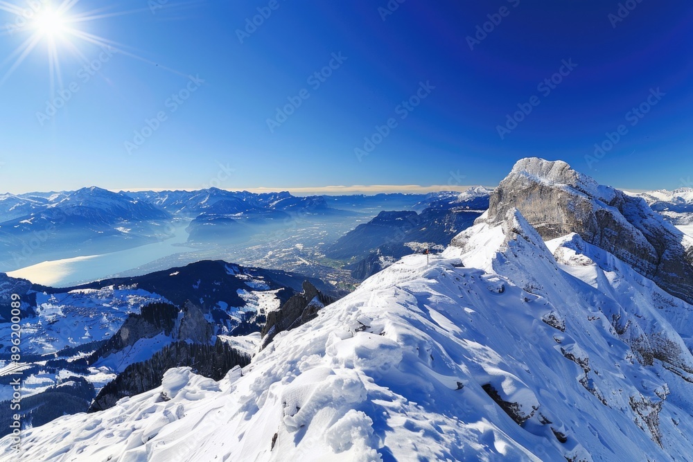 A person stands at the summit of a snow-covered mountain, enjoying the breathtaking view A person stands at the summit of a snow-covered mountain, enjoying the breathtaking view