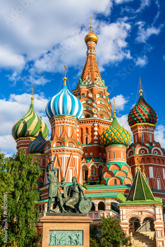 St. Basils Cathedral with monument of Minin and Pozharskiy. Red Square, Moscow. Capital of Russia. Summer sunny day. World famous Russian Moscow landmark. photo