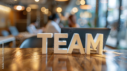 Team. Wooden letters stand on the table in office. Creating team of developers or for a successful business. photo