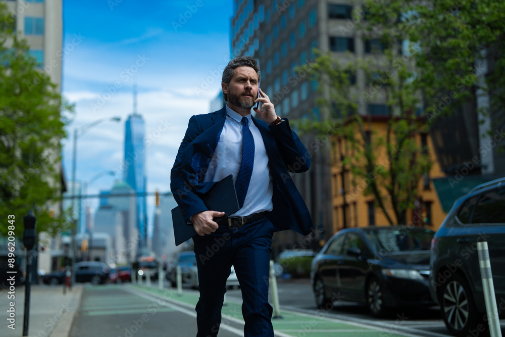 Businessman with phone run in NY. Business talk. Businessman run down street talking on the phone. Man in suit late. Business call. Running business man. Fast business. Run and late businessman. Businessman with phone run in NY. Business talk. Businessman run down street talking on the phone. Man in suit late. Business call. Running business man. Fast business. Run and late businessman.