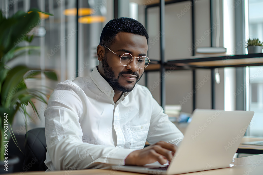 Obraz premium Handsome African American man in his 30s wearing a white shirt in the office, working in the modern office, looking in the camera