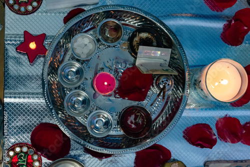 Silver tray with offerings and candles. Diwali rite at home. Religious tradition. Hindu festivity. photo