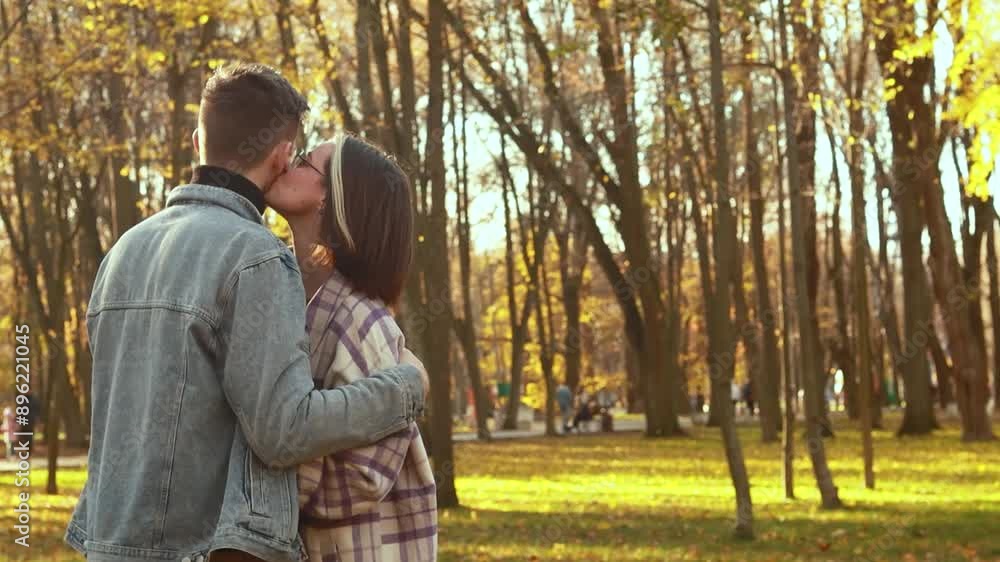 Heterosexual caucasian young loving couple walking outside in the city park sunny weather, hugging smiling kissing laughing spending time together. Autumn, fall season, orange yellow red maple leaves
Heterosexual caucasian young loving couple walking outside in the city park sunny weather, hugging smiling kissing laughing spending time together. Autumn, fall season, orange yellow red maple leaves