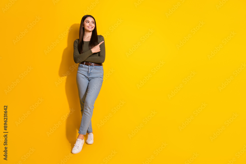 Fototapeta premium Full size photo of pretty teenager girl point look empty space wear trendy khaki outfit isolated on yellow color background