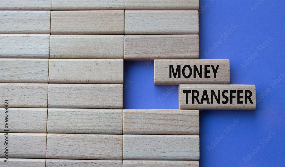 Money Transfer symbol. Concept word Money Transfer on wooden blocks. Beautiful purple background. Business and Money Transfer concept. Copy space Money Transfer symbol. Concept word Money Transfer on wooden blocks. Beautiful purple background. Business and Money Transfer concept. Copy space