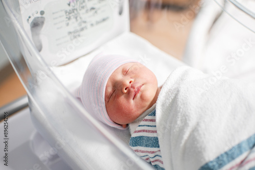 Just born swaddled newborn baby at the hospital. Baby's birth day. 