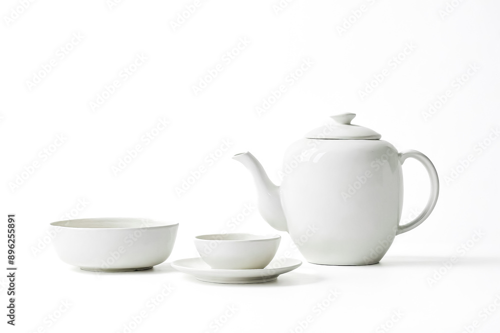 White Teapot, Cup and Saucer, and Bowl Isolated on White Background White Teapot, Cup and Saucer, and Bowl Isolated on White Background