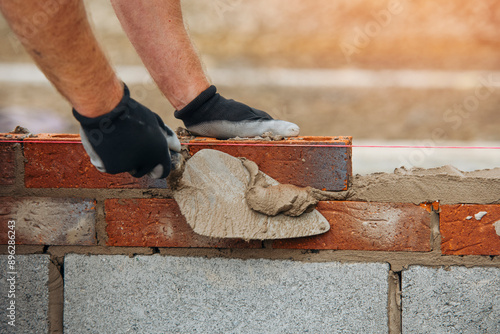 Konstfotografi Construction Worker Placing Brick in Mortar Using Trowel