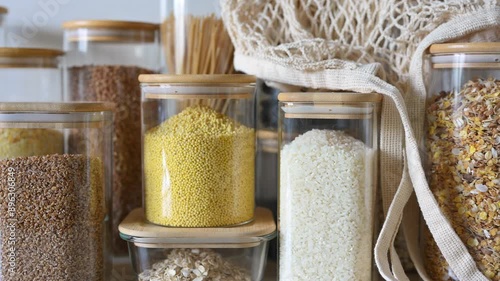 Close-up of glass jars with cereals and pasta. Reusable eco-friendly food storage jars. Zero waste concept