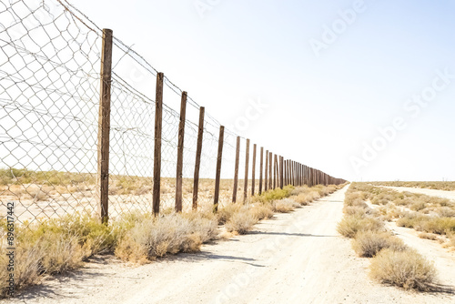 A long fence line in the desert