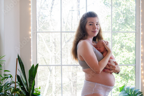 Mother with newborn baby. Postpartum. Fourth trimester. Body positivity. Postpartum body
