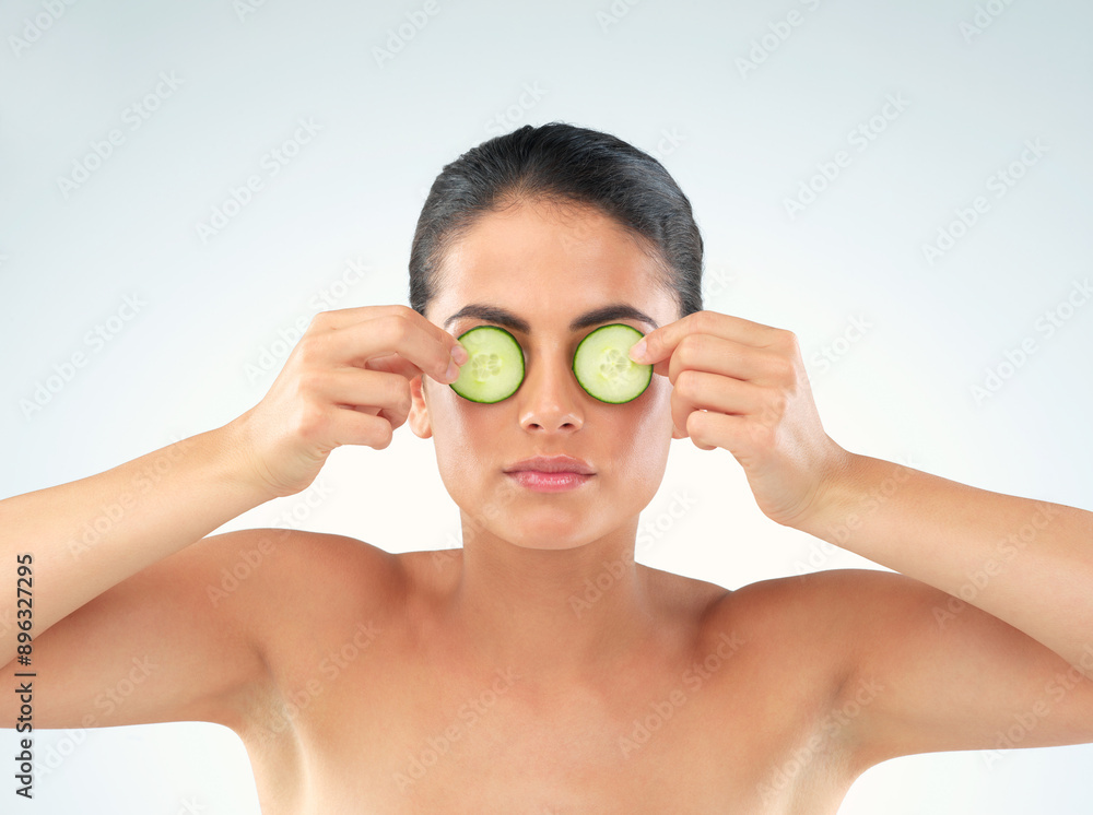 Skincare, woman and cucumber on eyes for beauty isolated on white studio background. Facial treatment, health or model with vegetable on face for wellness, detox or organic food for natural cosmetics Skincare, woman and cucumber on eyes for beauty isolated on white studio background. Facial treatment, health or model with vegetable on face for wellness, detox or organic food for natural cosmetics