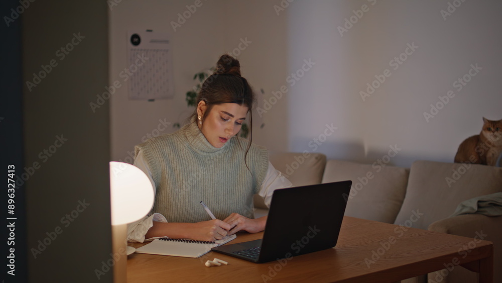 Organized student girl writing notebook evening workplace closeup. Woman working Organized student girl writing notebook evening workplace closeup. Woman working