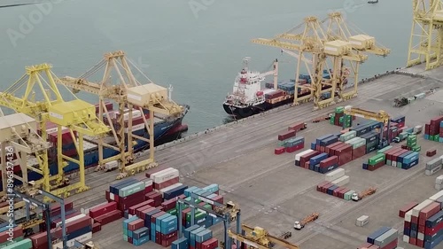 Semarang, Indonesia  - July 22, 2024.

ariel view a trade port bustling with activity as cargo ships load and unload,  a symphony of industry in motion.