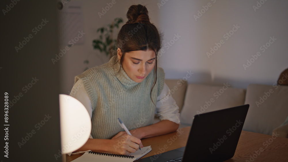 Focused student working laptop at lamp light flat closeup. Freelancer writing Focused student working laptop at lamp light flat closeup. Freelancer writing