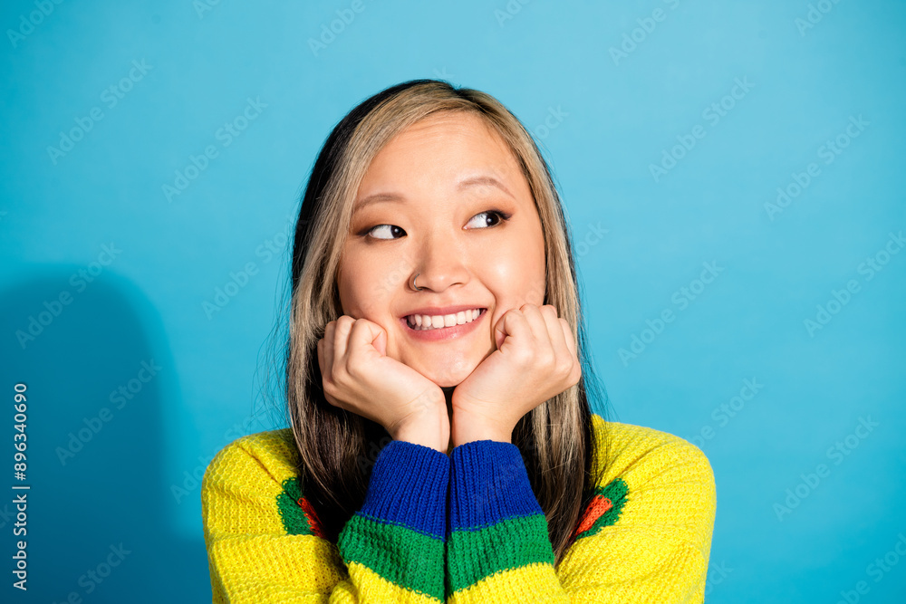 Photo portrait of attractive young woman look empty space admire dressed stylish striped clothes isolated on blue color background Photo portrait of attractive young woman look empty space admire dressed stylish striped clothes isolated on blue color background