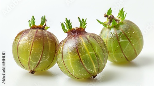 Three gooseberries with green leaves isolated on white background. photo