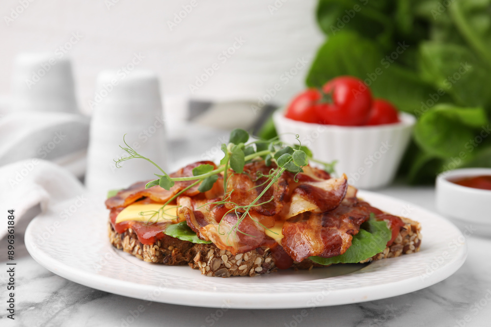 Tasty sandwich with bacon and microgreens on white marble table, closeup Tasty sandwich with bacon and microgreens on white marble table, closeup