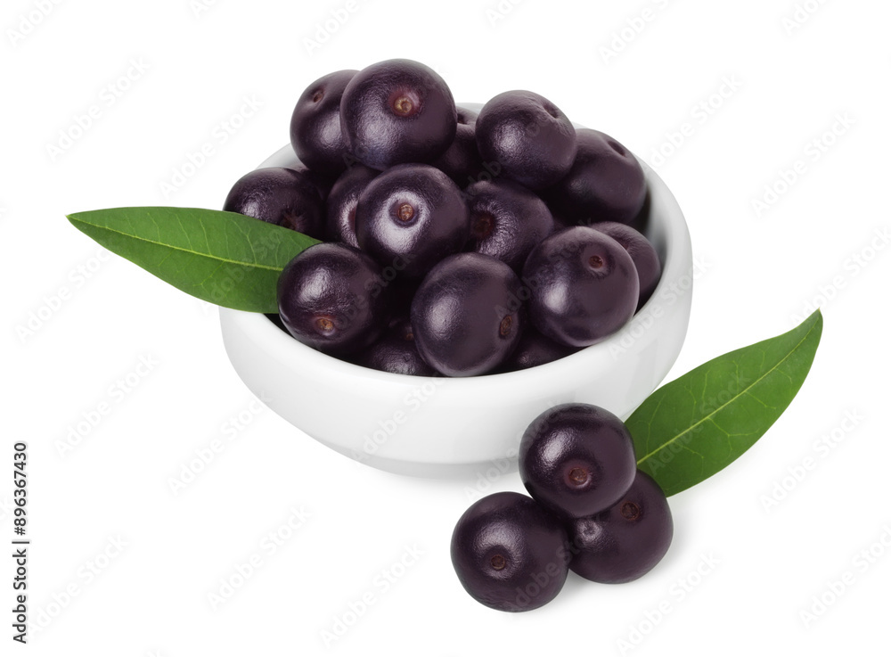 Fresh ripe acai berries in bowl and green leaves isolated on white Fresh ripe acai berries in bowl and green leaves isolated on white