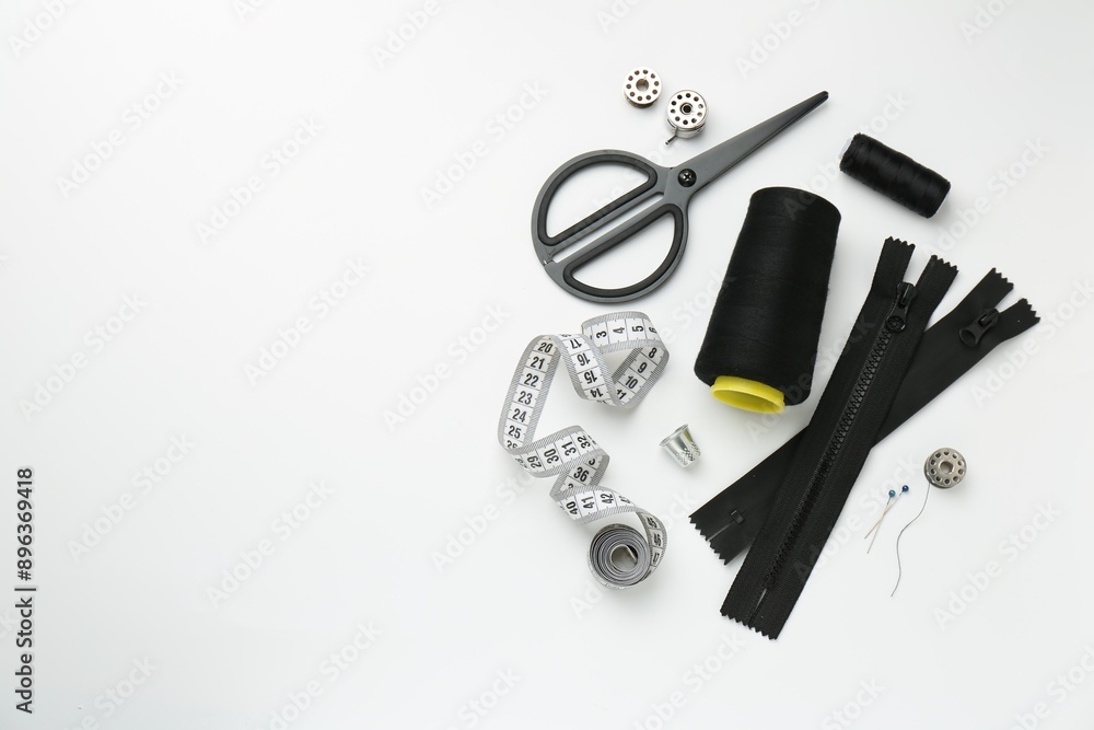 Flat lay composition with different sewing supplies on white background. Space for text Flat lay composition with different sewing supplies on white background. Space for text