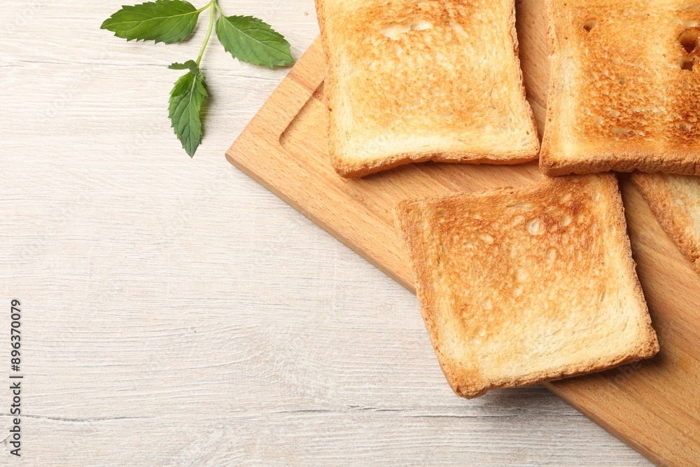 Slices of delicious toasted bread on wooden table, top view. Space for text Slices of delicious toasted bread on wooden table, top view. Space for text