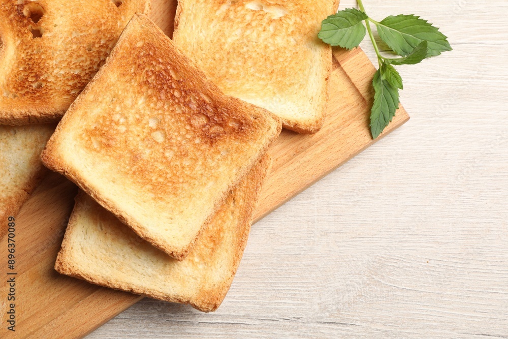 Slices of delicious toasted bread on wooden table, top view Slices of delicious toasted bread on wooden table, top view