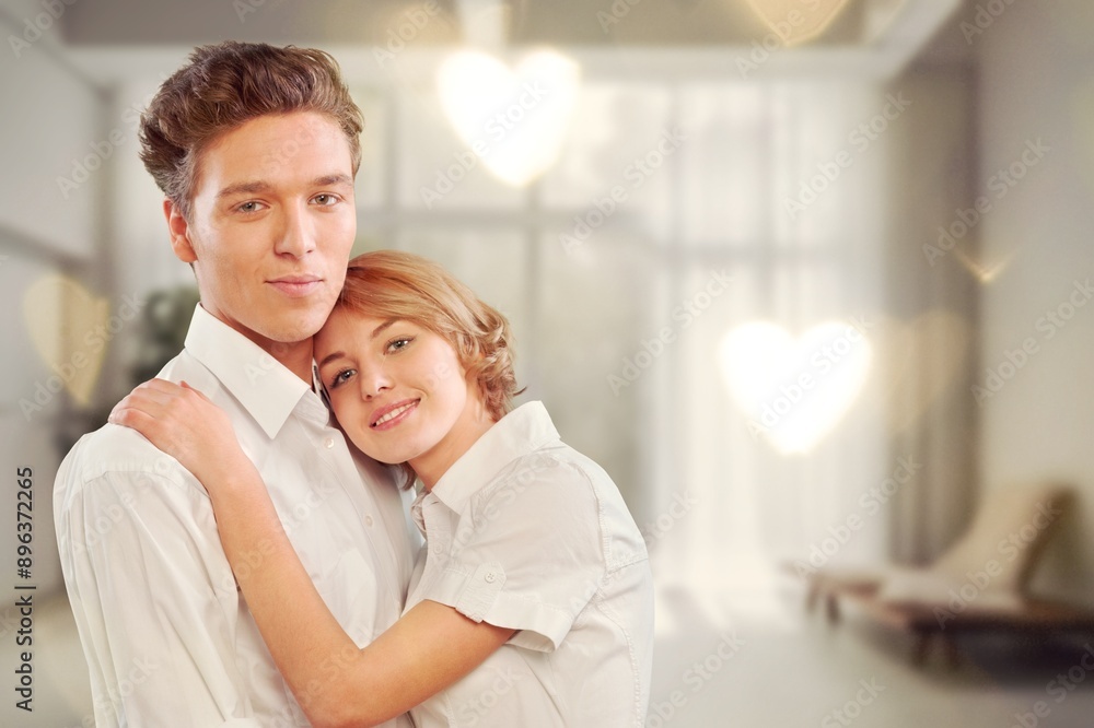 Fototapeta premium Valentine's Day concept. Young couple hugging at home.