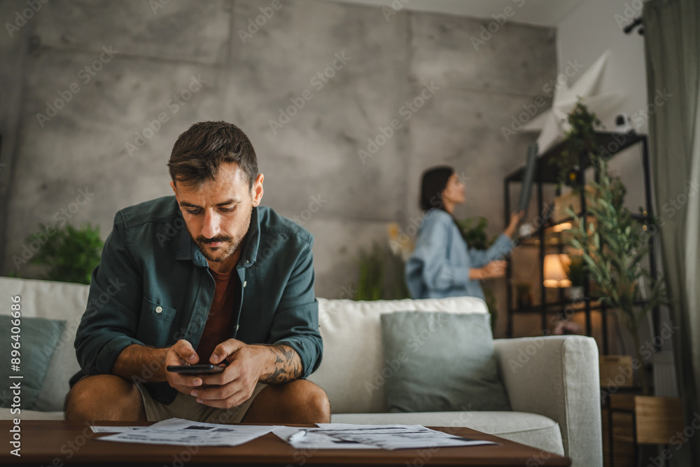 Adult man check invoice and prepare to do contactless payment Adult man check invoice and prepare to do contactless payment