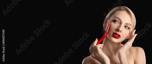 Sexy young woman with chili...