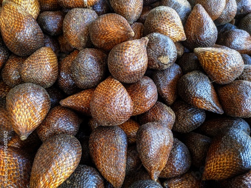 alak (Salacca zalacca) - Large amounts of snake fruit. Fresh snake fruit on the wood. Thorny Palm