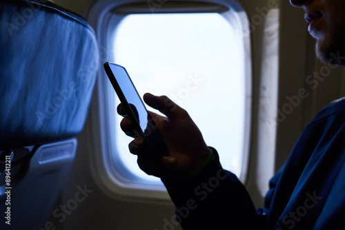 Fotografi Man, hands and smartphone in airplane with journey for traveling, social media and networking
