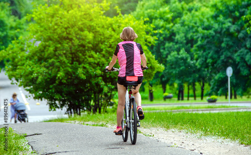Wallpaper Mural Cyclist ride on the bike path in the city Park
 Torontodigital.ca