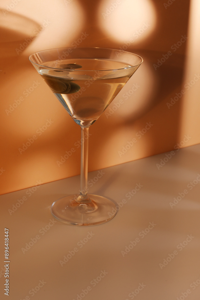 Glass of martini with olives on color background Glass of martini with olives on color background