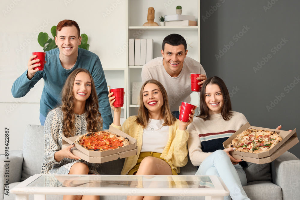 Group of young friends with beer and pizza at home party Group of young friends with beer and pizza at home party